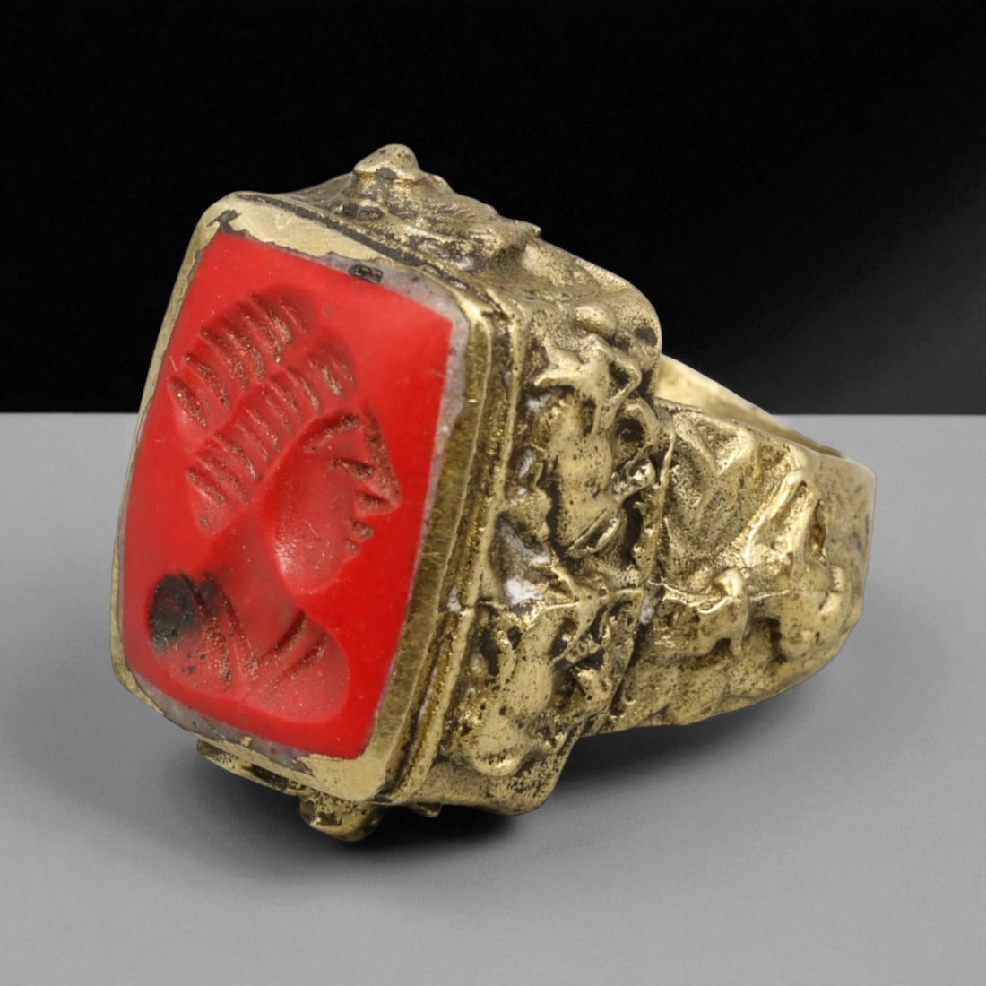 Antique Qajar Gold Gilt Intaglio Signet Ring, c. 19th-20th Century, 6.5 US: This substantial gilt ring, dating to the Qajar era of the 19th-20th century, embodies the regal aesthetic and cultural refinement of Persian jewelry traditions. The bezel is set with an engraved inta