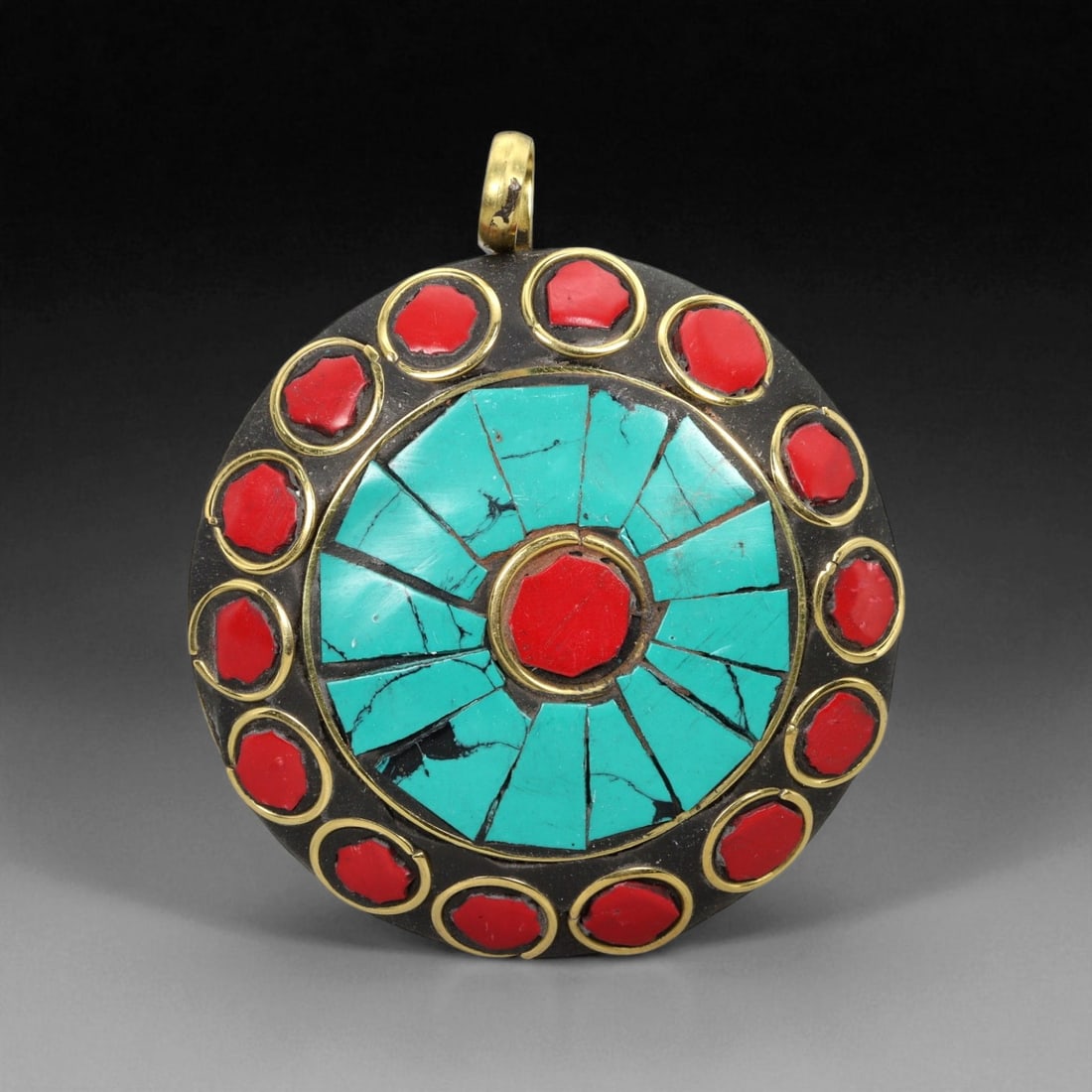 Vintage Himalayan Tribal Turquoise and Coral Sunburst Brass Pendant, 20th Century, 6cm: This radiant round pendant embodies the bold, spiritual aesthetics of Himalayan tribal jewelry, where color and form converge to express cosmic harmony. Its design centers on a circular turquoise inla