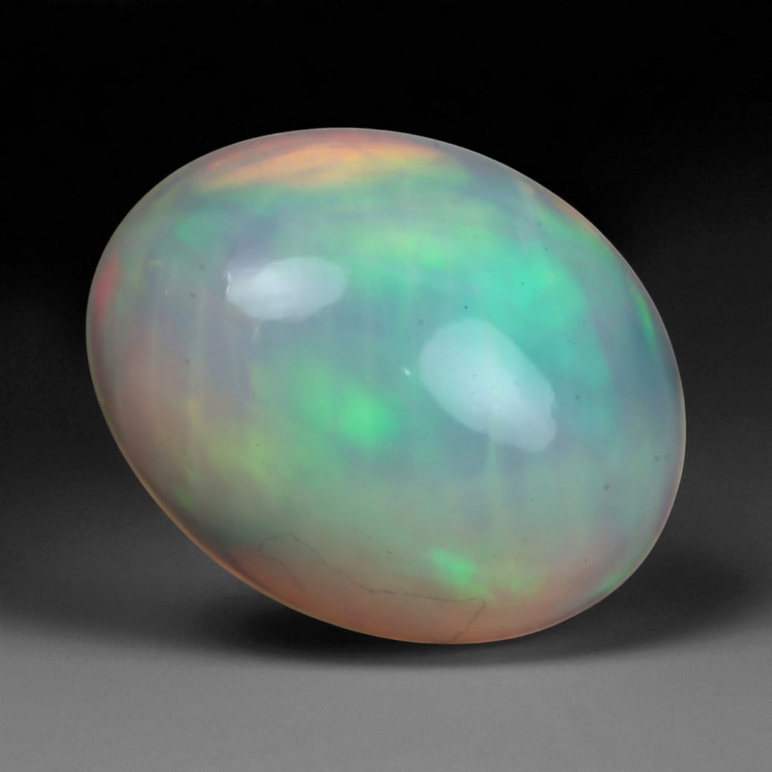 2.04 Carats Multi-Color Welo Opal Lot - Natural Ethiopian Stones: This radiant group of Welo opals displays a mesmerizing interplay of color that dances across the surface with every shift of light. Electric flashes of green, orange, and red ripple through a translu