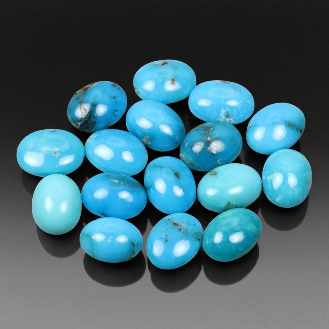 14.81 Carats Sky Blue Turquoise Cabochon Parcel - Natural Iranian Stones: This elegant parcel of turquoise cabochons showcases a radiant spectrum of sky to robin's-egg blue tones, interspersed with delicate matrix veining that adds natural character to each gem 8x6x3mm. The