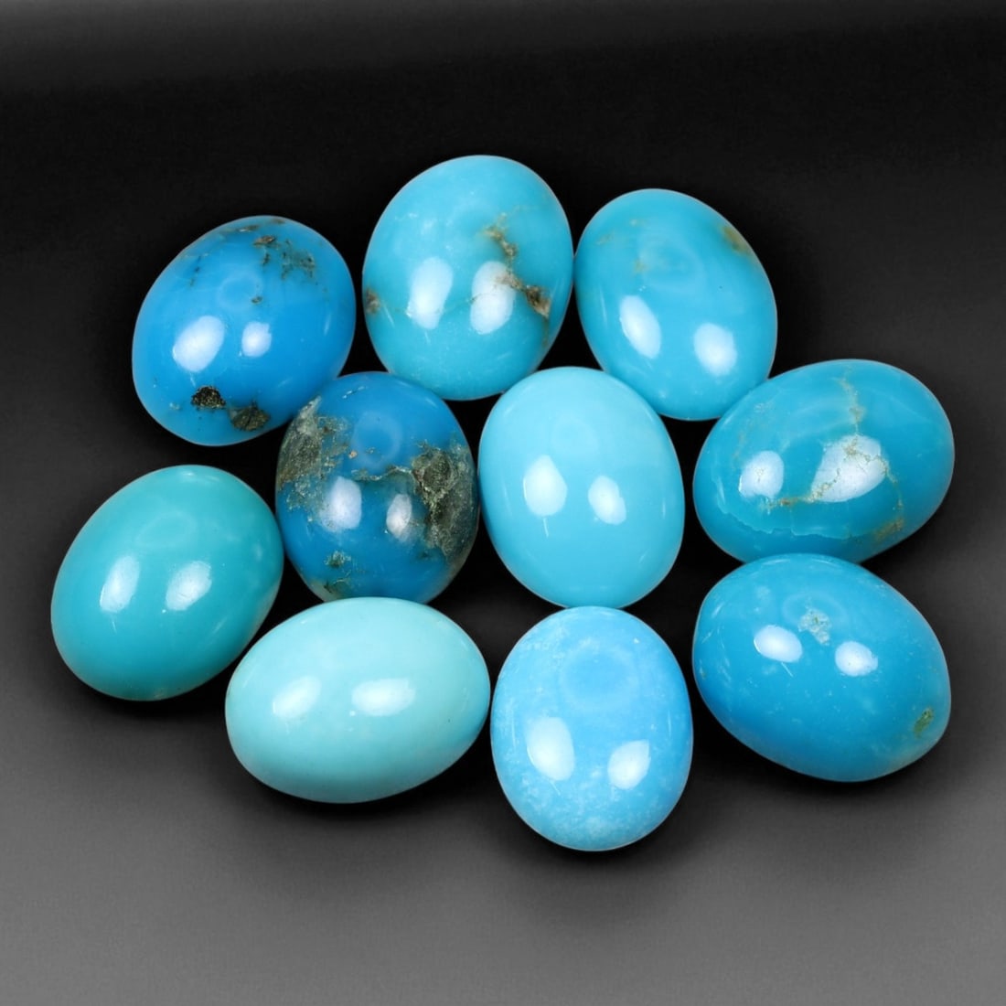 10.29 Carats Sky Blue Turquoise Cabochon Parcel - Natural Iranian Stones: This elegant parcel of turquoise cabochons showcases a radiant spectrum of sky to robin's-egg blue tones, interspersed with delicate matrix veining that adds natural character to each gem 8x6x3mm. The