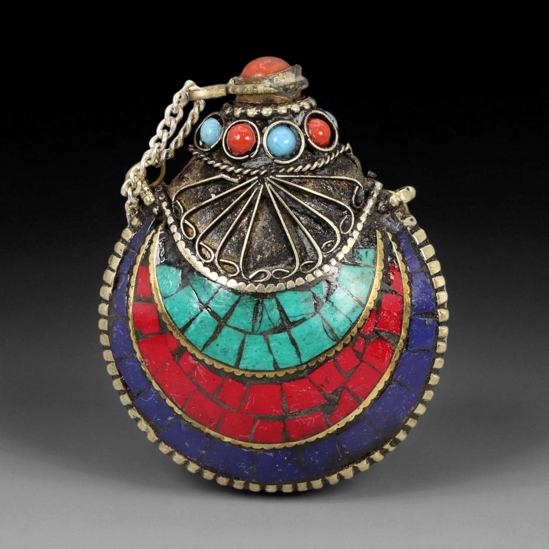 Vintage Himalayan Tribal Coral, Turquoise, and Lapis Brass Perfume Flask Pendant, 20th Century, 6cm: This exquisite round perfume flask captures the vibrant aesthetic and devotional craftsmanship of Himalayan tribal artistry. Its intricate mosaic surface displays concentric arcs of turquoise, coral,