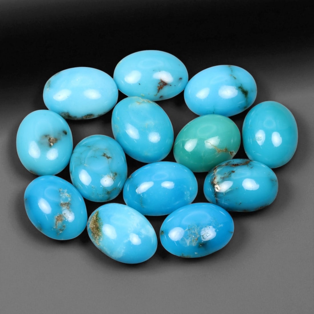 12.38 Carats Sky Blue Turquoise Cabochon Parcel - Natural Iranian Stones: This elegant parcel of turquoise cabochons showcases a radiant spectrum of sky to robin's-egg blue tones, interspersed with delicate matrix veining that adds natural character to each gem 8x6x3mm. The