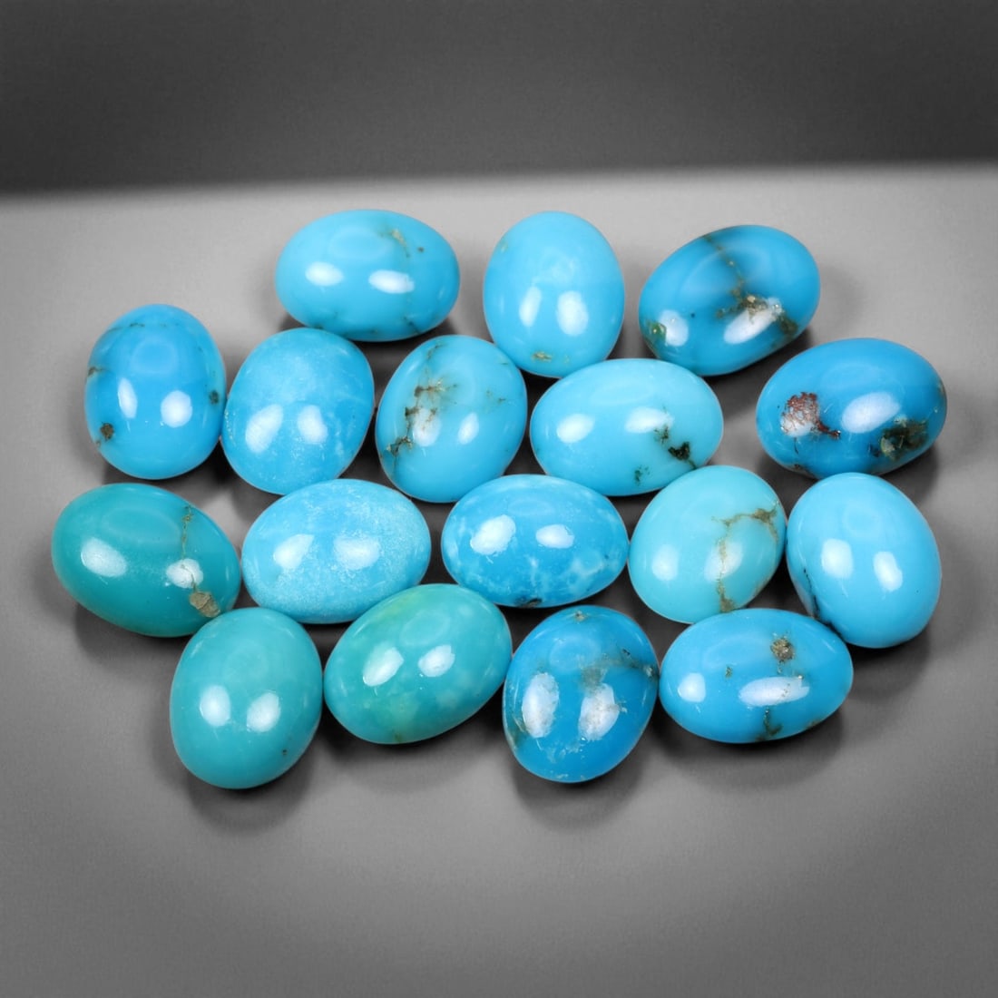 15.08 Carats Sky Blue Turquoise Cabochon Parcel - Natural Iranian Stones: This elegant parcel of turquoise cabochons showcases a radiant spectrum of sky to robin's-egg blue tones, interspersed with delicate matrix veining that adds natural character to each gem 8x6x3mm. The
