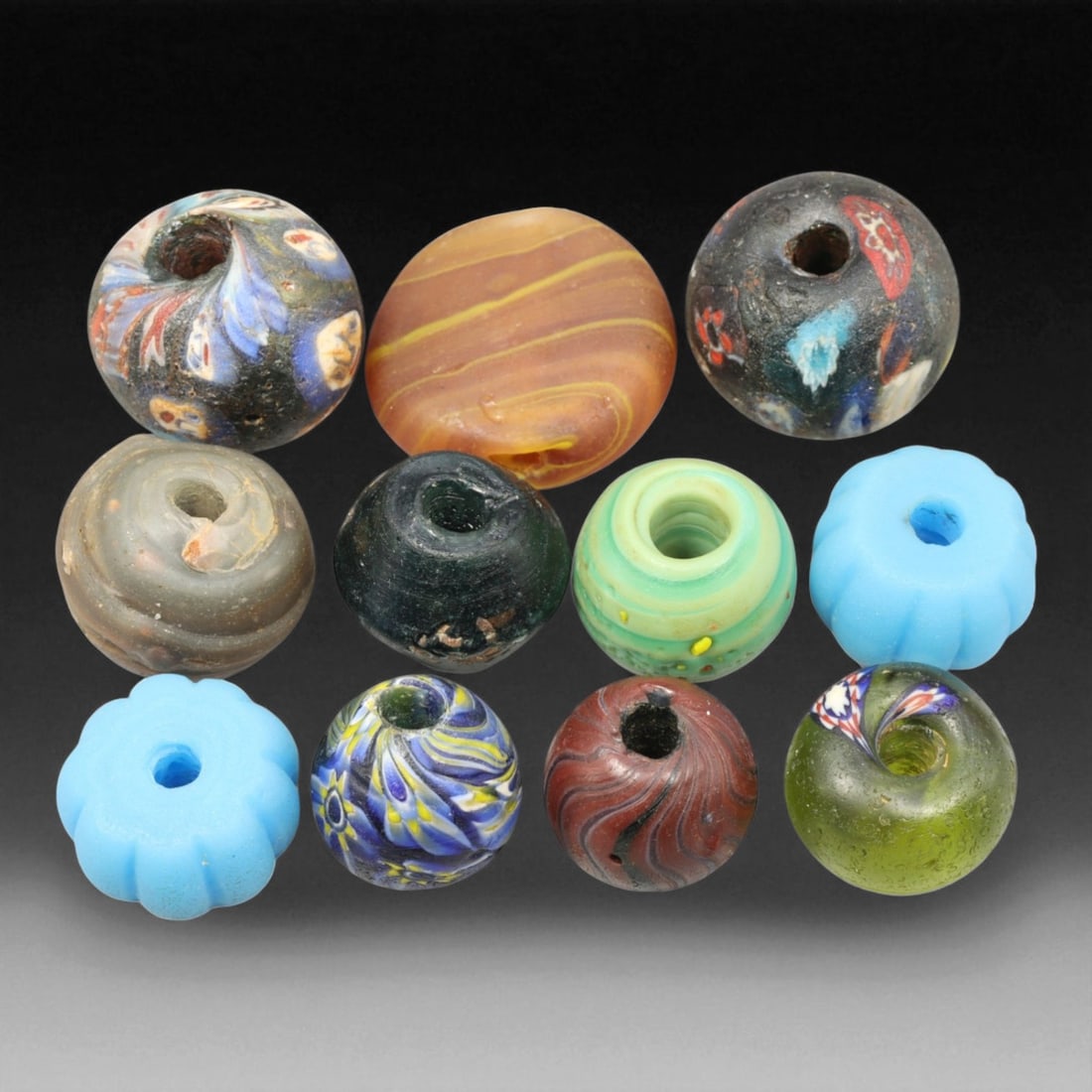 Antique Mixed Venetian and Indo-Pacific Glass Trade Beads, c. 19th-20th Century, 1.5-2cm: This diverse collection of antique glass trade beads, dating from the 19th to early 20th century, beautifully illustrates the international exchange of color and craft that defined the global bead tra