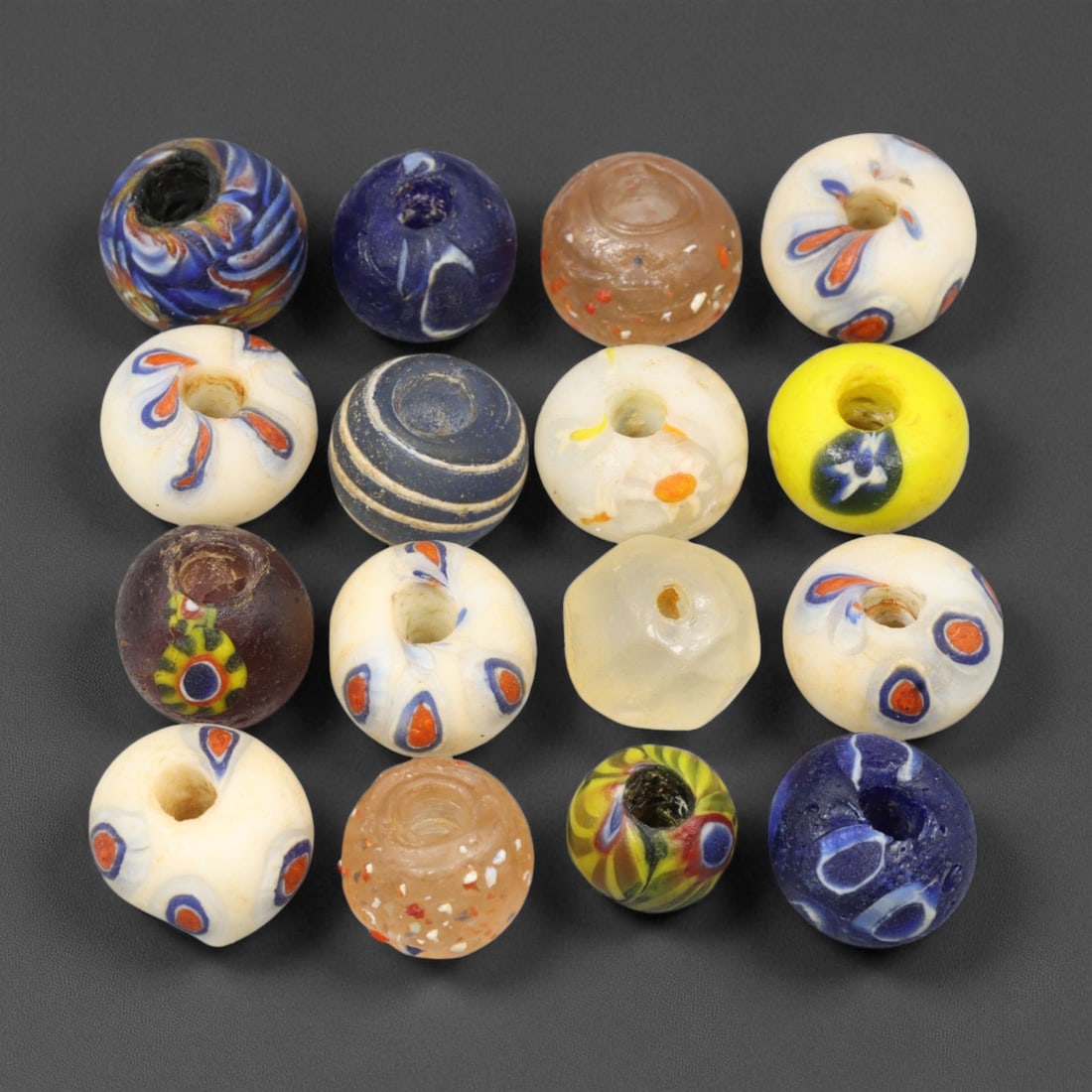 Antique Venetian and Indo-Pacific Multicolor Glass Trade Beads, c. 19th-20th Century, 1-1.7cm: This vibrant collection of antique multicolor glass trade beads, dating from the 19th to early 20th century, reflects the artistic mastery and global reach of Venetian and Indo-Pacific glassmaking tra