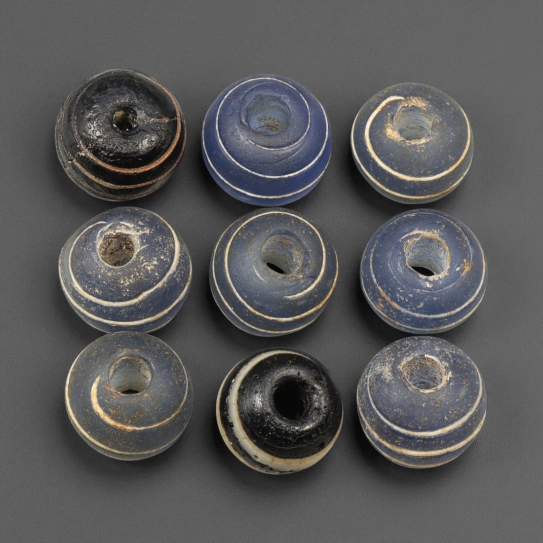 Antique Indo-Pacific Blue Glass Eye Beads, c. 18th-19th Century 1.2cm: These antique blue glass beads, dating to the 18th-19th century, represent the enduring craftsmanship of Indo-Pacific glassmaking traditions that flourished along ancient maritime trade routes. Their 