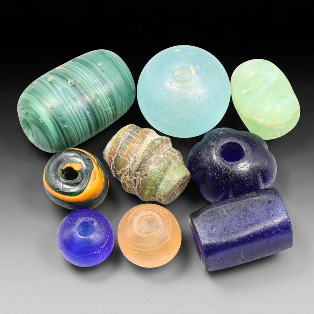 Antique Venetian Multicolor Glass Trade Beads, c. 19th Century, 1.6-3.8cm: This collection of antique Venetian glass trade beads, dating from the 19th century, reflects the vibrant artistry of Murano glassmakers during Venice's global era of maritime trade. Each bead was ind