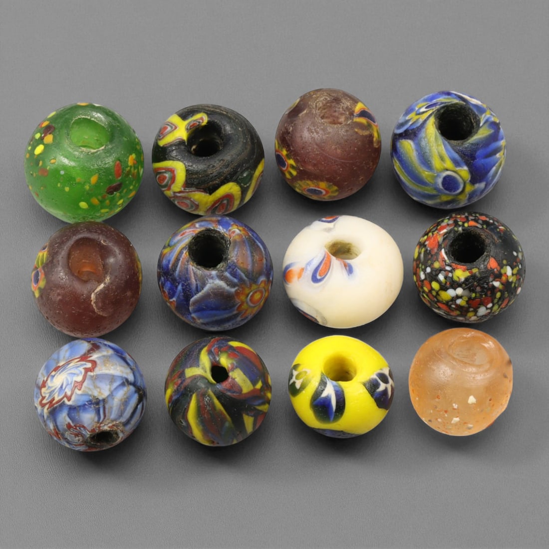 Antique Venetian Multicolor Millefiori Glass Trade Beads, c. 19th-20th Century, 1-1.5cm: This colorful assemblage of antique Venetian millefiori glass trade beads, dating from the 19th to early 20th century, captures the height of Murano's glass artistry and the international influence of