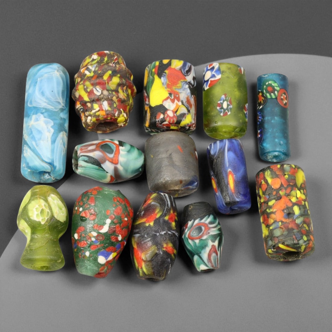 Antique Venetian Multicolor Millefiori Trade Beads, c. 19th Century, 2-3.4cm: These antique Venetian millefiori trade beads, dating to the 19th century, represent the height of Murano's glass artistry during an era when Venetian workshops supplied vibrant glass ornaments to glo