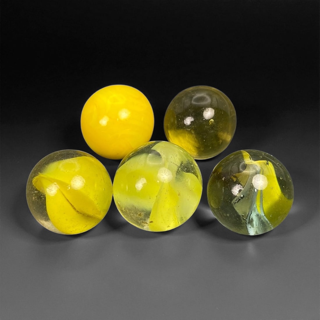 Vintage Glass Marbles Lot, Mid-20th Century, 1.4-1.6cm: This charming lot of vintage glass marbles, dating from the mid-20th century, reflects the artistry and playfulness of early handmade and molded glass craftsmanship. These marbles were produced during