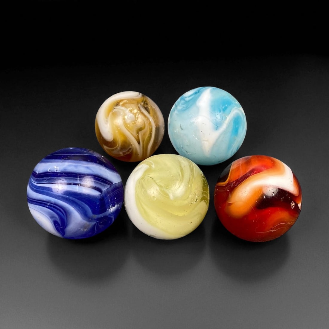 Vintage Glass Marbles Lot, Mid-20th Century, 1.5-1.9cm: This charming lot of vintage glass marbles, dating from the mid-20th century, reflects the artistry and playfulness of early handmade and molded glass craftsmanship. These marbles were produced during