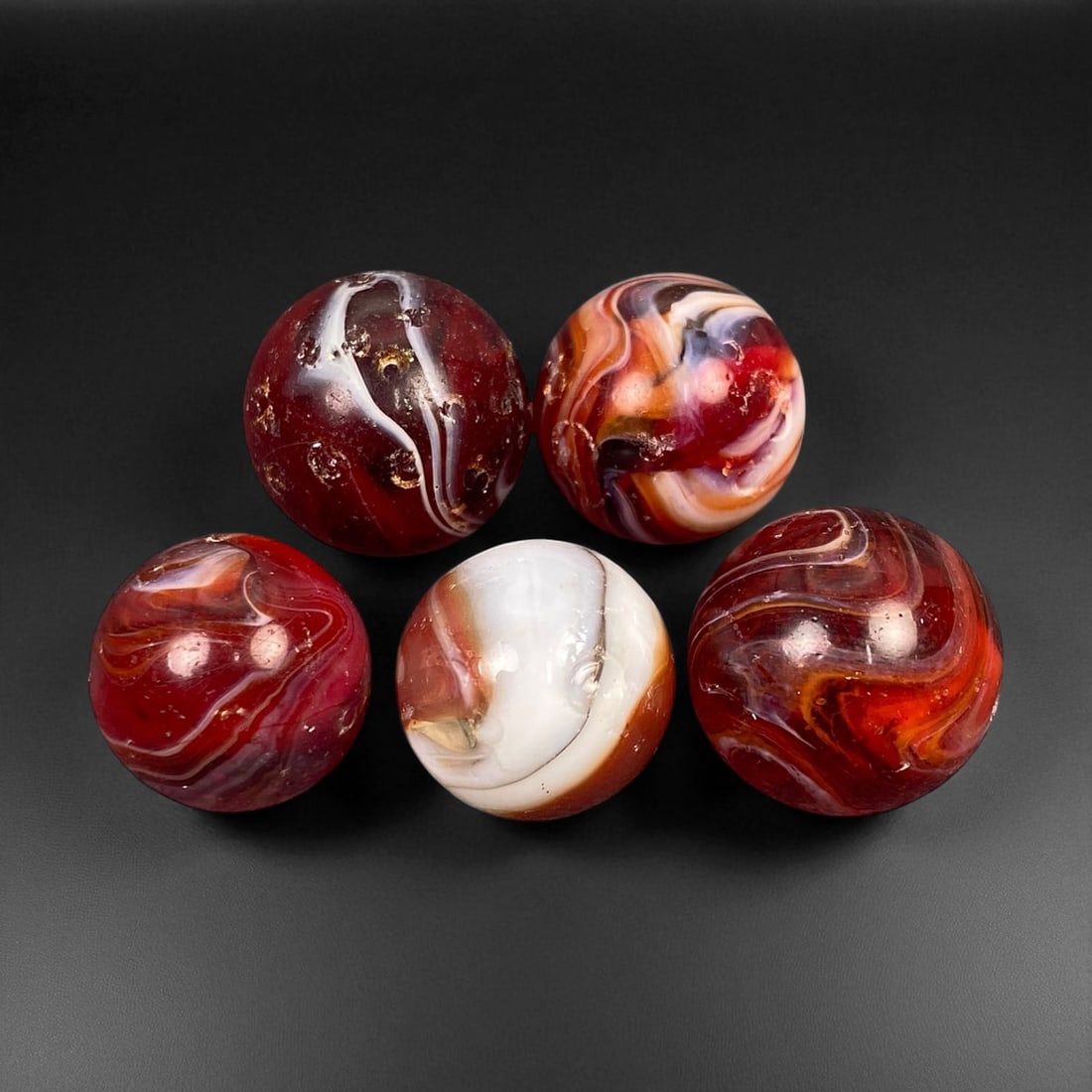 Vintage Glass Marbles Lot, Mid-20th Century, 1.5-1.7cm: This charming lot of vintage glass marbles, dating from the mid-20th century, reflects the artistry and playfulness of early handmade and molded glass craftsmanship. These marbles were produced during