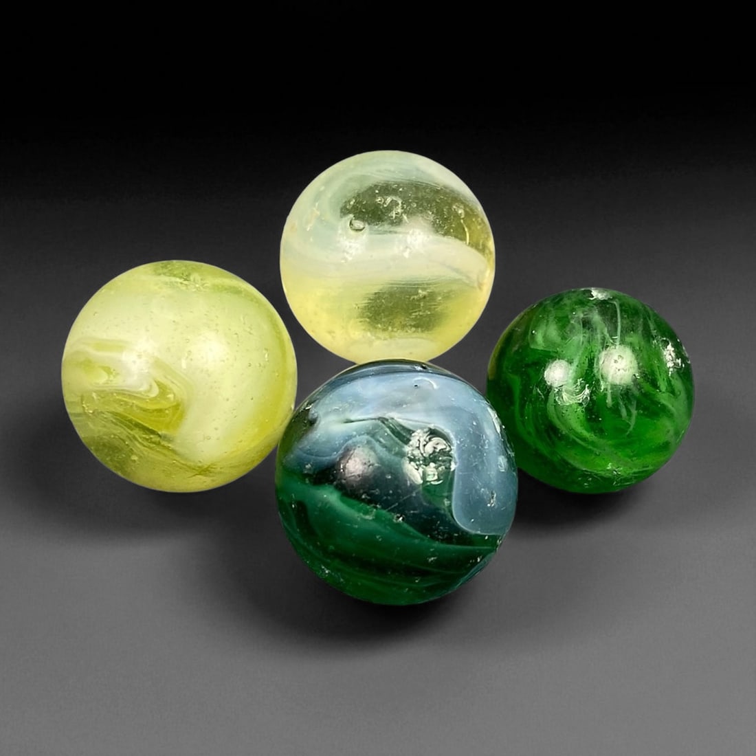 Vintage Glass Marbles Lot, Mid-20th Century, 1.4-1.6cm: This charming lot of vintage glass marbles, dating from the mid-20th century, reflects the artistry and playfulness of early handmade and molded glass craftsmanship. These marbles were produced during