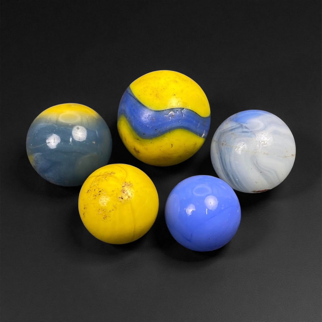 Vintage Glass Marbles Lot, Mid-20th Century, 1.4-1.8cm: This charming lot of vintage glass marbles, dating from the mid-20th century, reflects the artistry and playfulness of early handmade and molded glass craftsmanship. These marbles were produced during