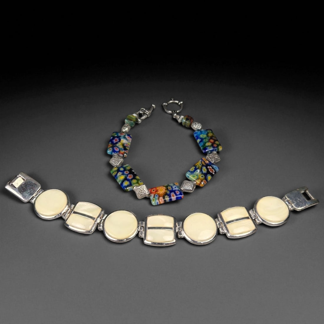 Set of Two Artistic Link Bracelets - Millefiori Glass and Cream Enamel Designs: This vibrant pair of bracelets combines artistic flair with elegant craftsmanship. Measuring approximately 7 cm each, the set offers a striking contrast of color and form-one playful and intricate, th