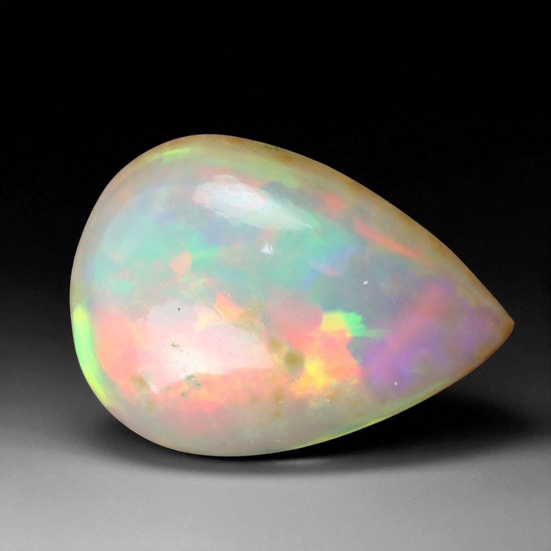 3.06 Carats Multi-Color Welo Opal Lot - Natural Ethiopian Stones: This radiant group of Welo opals displays a mesmerizing interplay of color that dances across the surface with every shift of light. Electric flashes of green, orange, and red ripple through a translu