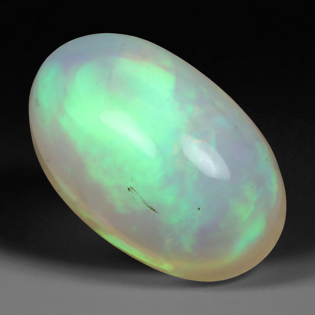 4.77 Carats Multi-Color Welo Opal Lot - Natural Ethiopian Stones: This radiant group of Welo opals displays a mesmerizing interplay of color that dances across the surface with every shift of light. Electric flashes of green, orange, and red ripple through a translu