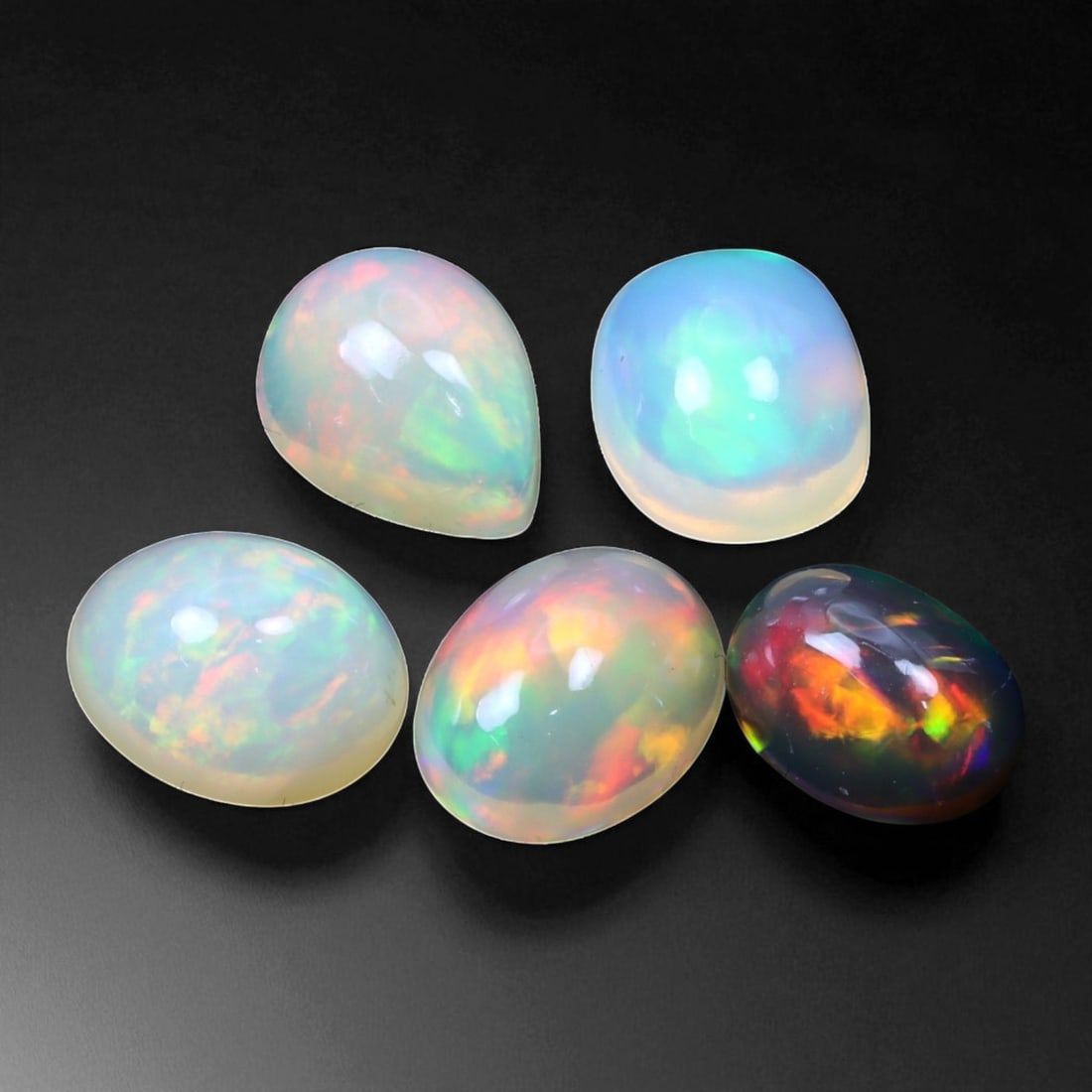 7.97 Carats Multi-Color Welo Opal Lot - Natural Ethiopian Stones: This radiant group of Welo opals displays a mesmerizing interplay of color that dances across the surface with every shift of light. Electric flashes of green, orange, and red ripple through a translu