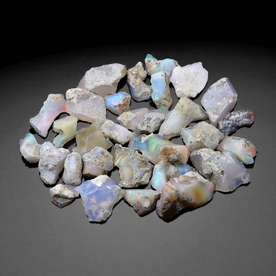 97.97 Carats Welo Opal Rough Parcel - Natural Ethiopian Stones: This striking parcel of natural Welo opal rough captures the enchanting play-of-color that has made Ethiopian material world-renowned. Displaying vivid flashes of electric green, fiery orange, neon bl