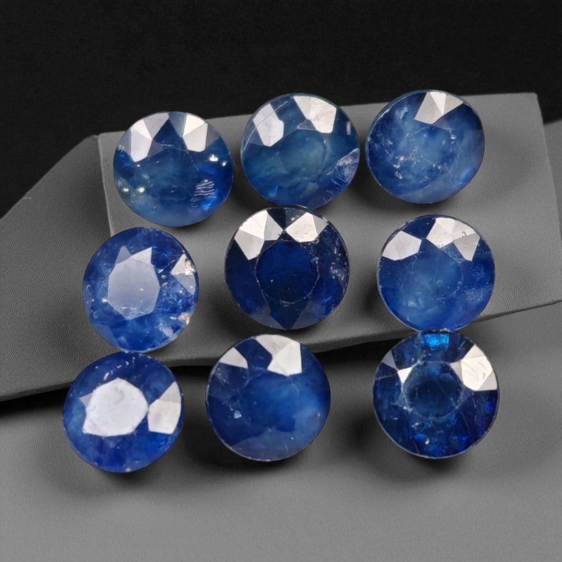 5.87 Carats Royal Blue Sapphire Round Lot - Natural Ceylon Stones: This captivating lot of round-cut sapphires exhibits a deep royal blue color, rich and even, with flashes of lighter brilliance across the facets. Each stone, measuring approximately 4.8x3.3mm, is gra
