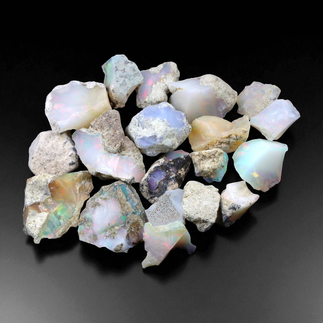 89.67 Carats Welo Opal Rough Parcel - Natural Ethiopian Stones: This striking parcel of natural Welo opal rough captures the enchanting play-of-color that has made Ethiopian material world-renowned. Displaying vivid flashes of electric green, fiery orange, neon bl