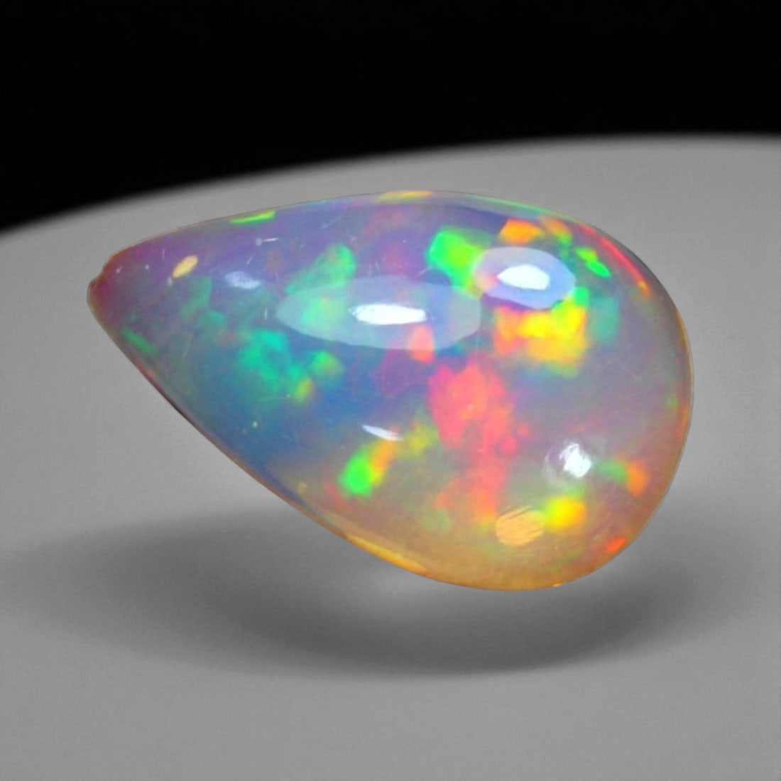 3.59 Carats Multi-Color Welo Opal Lot - Natural Ethiopian Stones: This radiant group of Welo opals displays a mesmerizing interplay of color that dances across the surface with every shift of light. Electric flashes of green, orange, and red ripple through a translu