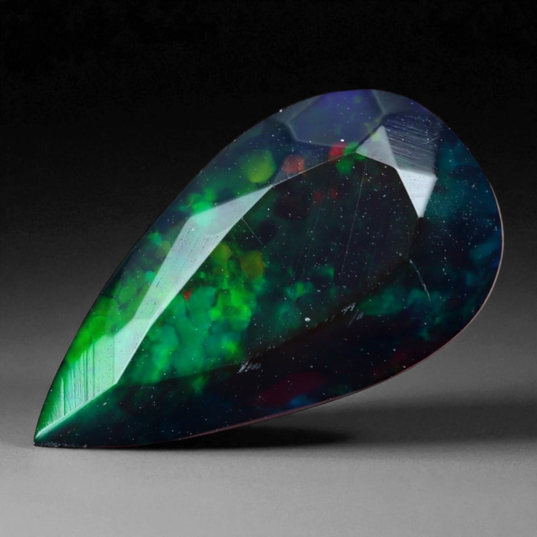 2.20 Carats Dark Fire Opal Faceted Selection - Natural Ethiopian Stones: This dramatic selection of dark Ethiopian opal faceted exhibits a captivating interplay of color set against deep, smoky body tones. Flashes of crimson, emerald, and violet ignite within the stones, p