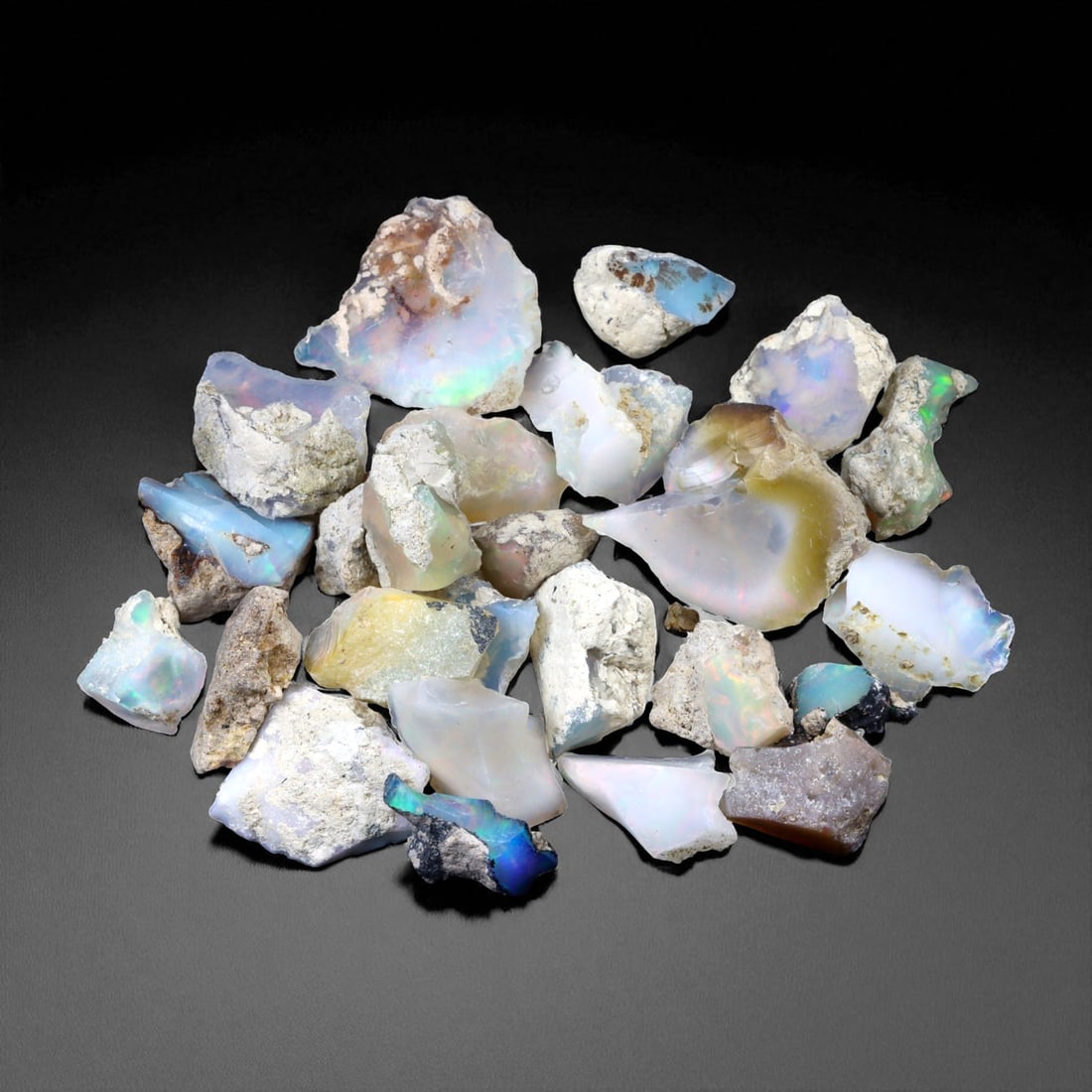 85.92 Carats Welo Opal Rough Parcel - Natural Ethiopian Stones: This striking parcel of natural Welo opal rough captures the enchanting play-of-color that has made Ethiopian material world-renowned. Displaying vivid flashes of electric green, fiery orange, neon bl