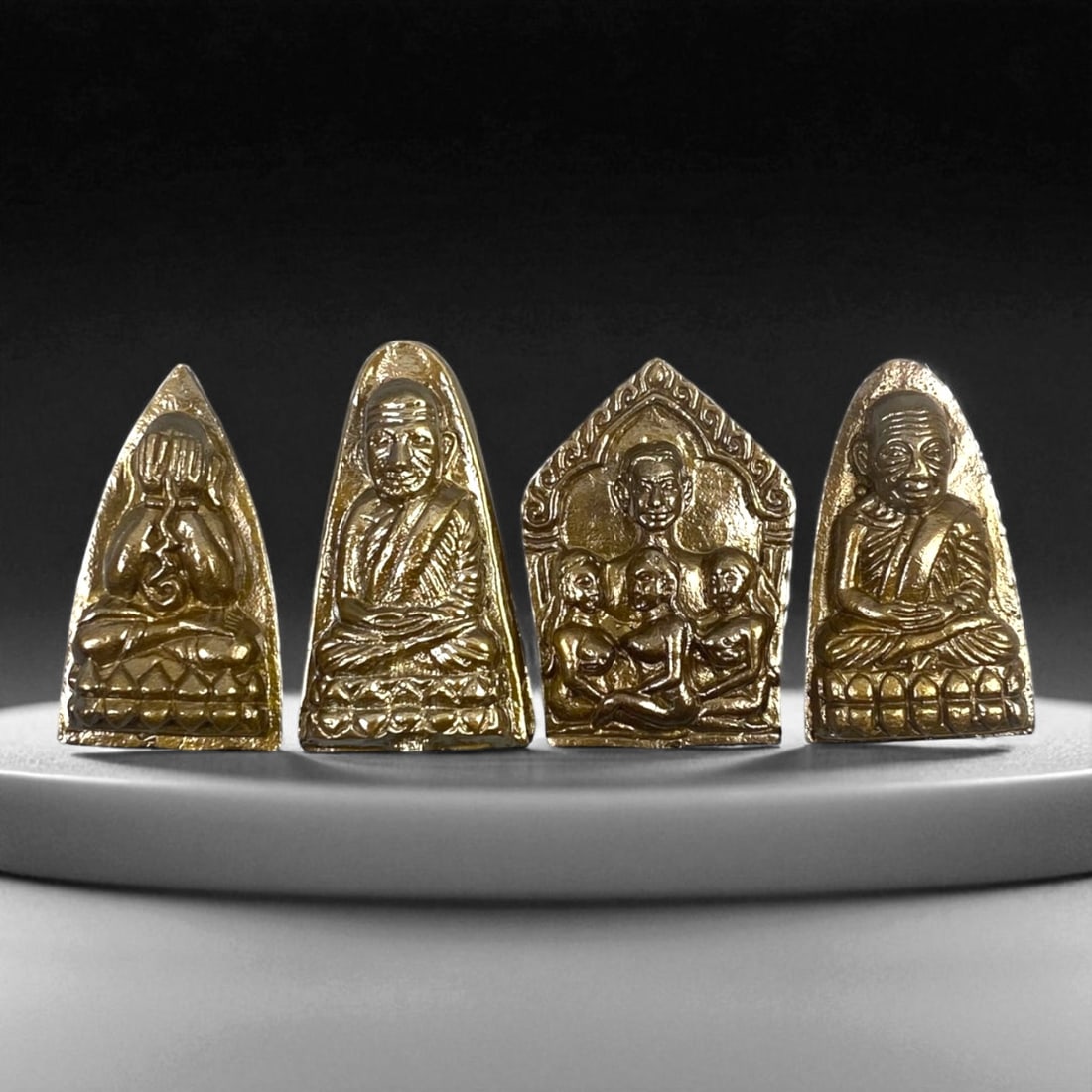 Vintage Thai Bronze Monk and Buddha Amulet Set, c. 20th Century 3.5-4cm: This elegant collection of four vintage Thai bronze amulets reflects the sacred artistry and devotional symbolism central to 20th-century Thai Buddhist culture. Each piece is finely cast in a warm gol