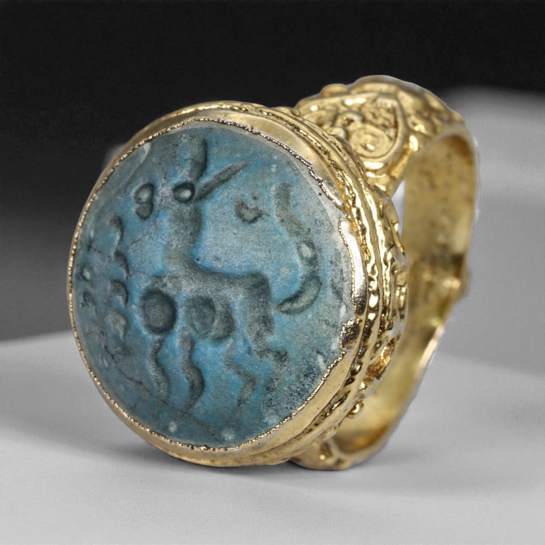 Antique Qajar Gold Gilt Intaglio Signet Ring, c. 19th-20th Century, 9 US, 17g: This substantial gilt ring, dating to the Qajar era of the 19th-20th century, embodies the regal aesthetic and cultural refinement of Persian jewelry traditions. The bezel is set with an engraved inta
