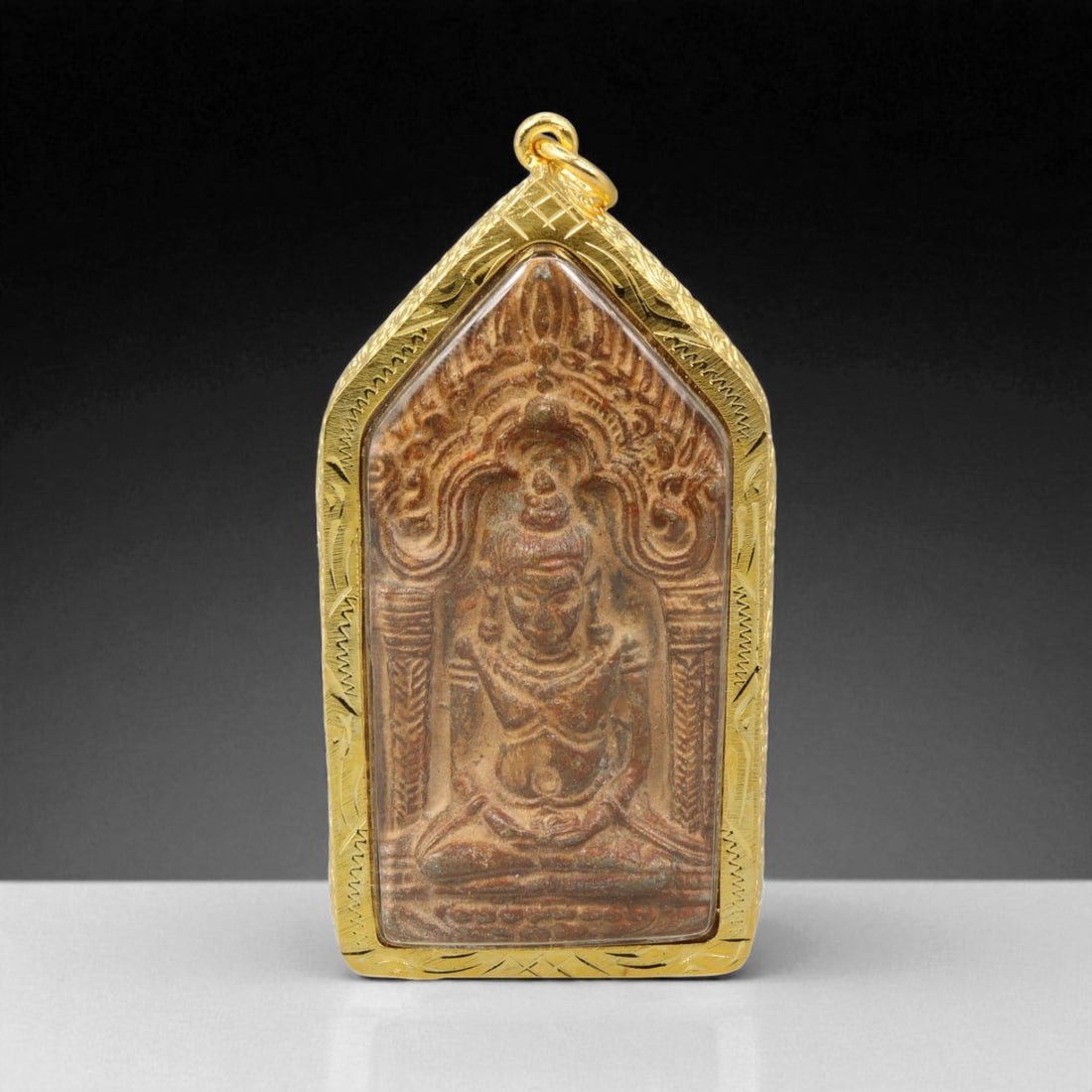 Thai Temple Gilt Buddhist Amulet in Ornate Gold-Tone Frame, 7.5cm: This beautifully crafted gilt Buddhist amulet is enclosed within an intricately designed gold-tone frame, combining sacred symbolism with refined artistry. The detailed relief and lustrous finish refl