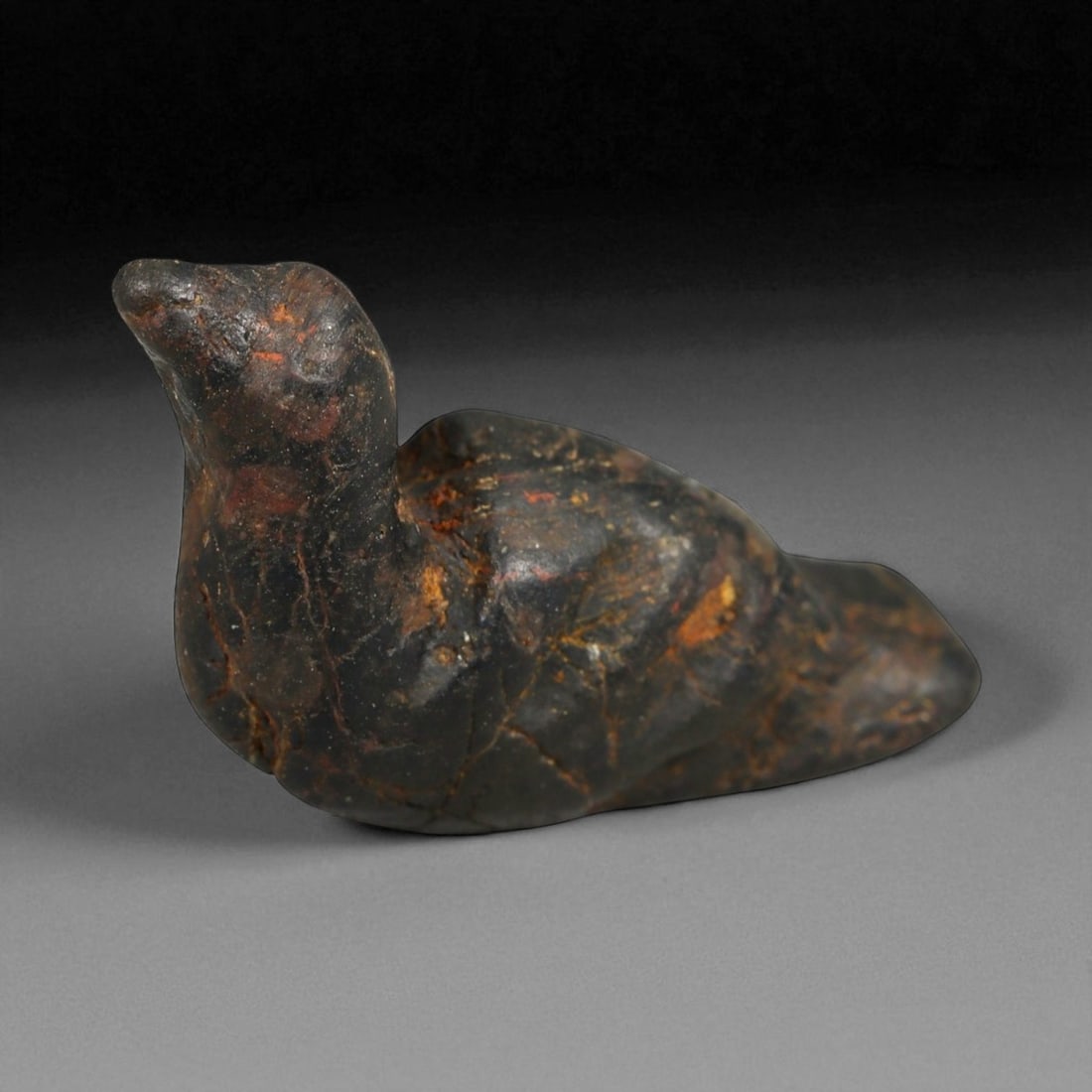 Ancient Egyptian Black Stone Bird Amulet, c. Late Period, 664-332 BCE, 3.2cm: This elegant black stone bird amulet, measuring 3.2 centimeters in length, originates from Ancient Egypt's Late Period (circa 664-332 BCE). The piece embodies the refined minimalism and spiritual symb