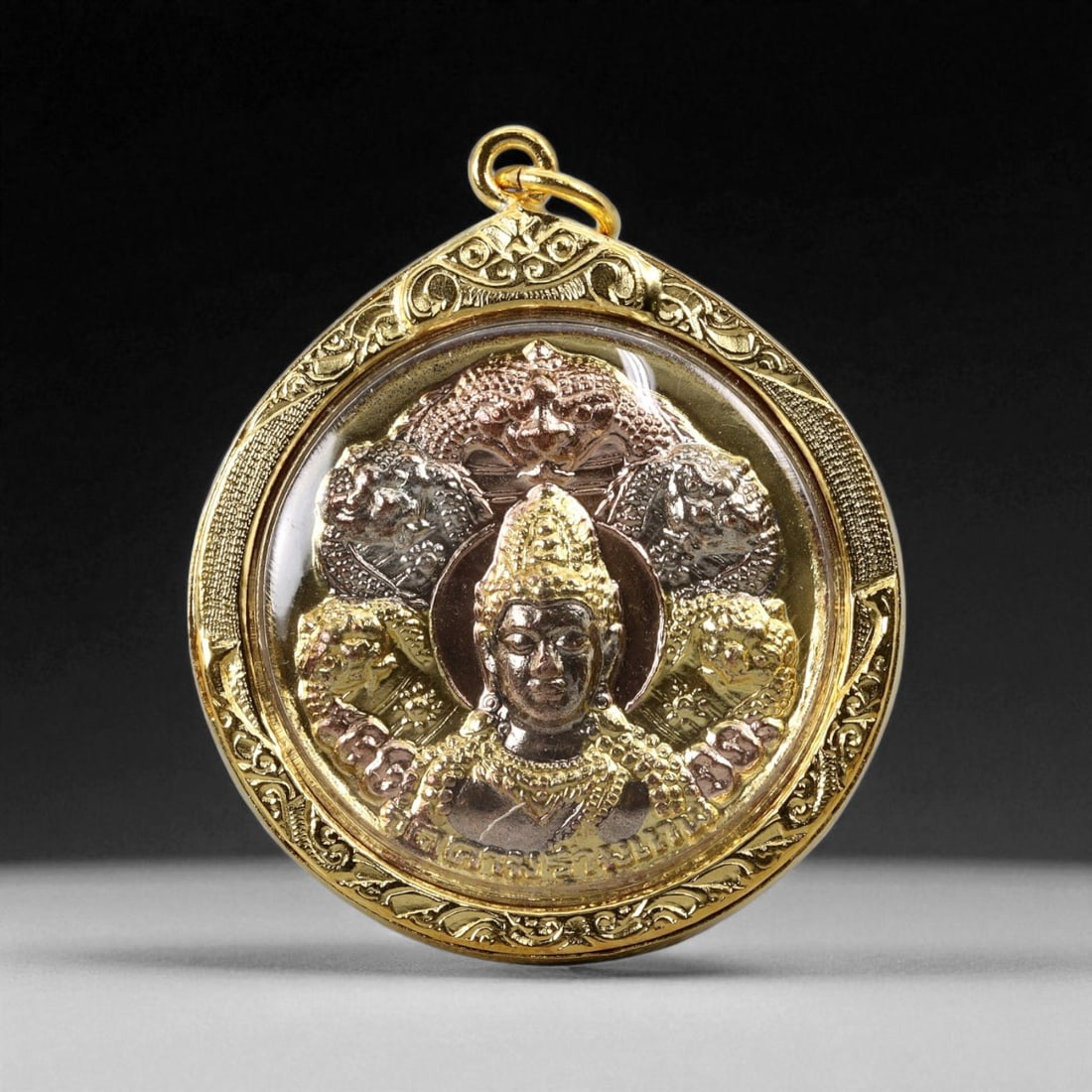 Thai Temple Style Gilt Buddhist Amulet in Ornate Gold-Tone Frame, 5cm: This beautifully crafted gilt Buddhist amulet is enclosed within an intricately designed gold-tone frame, combining sacred symbolism with refined artistry. The detailed relief and lustrous finish refl