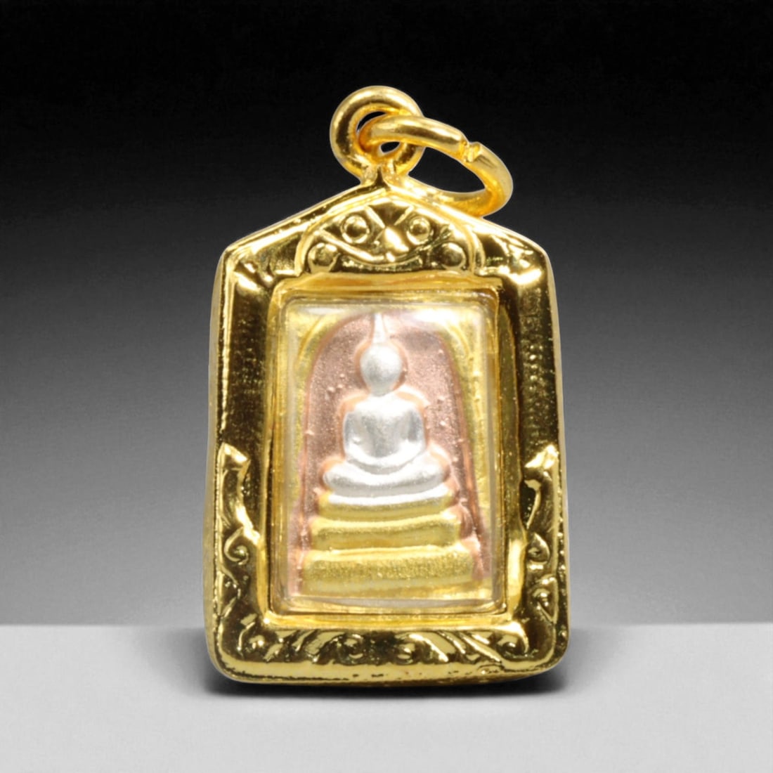 Thai Buddhist Triple-Gem Reliquary Gold-Tone Amulet Pendant, Rattanakosin Era Style, 5g: Evoking the spiritual sanctity of Thai Buddhist devotion, this finely crafted pendant houses a miniature image of the Buddha seated serenely upon a three-tiered throne - symbolizing the Triple Gem: th