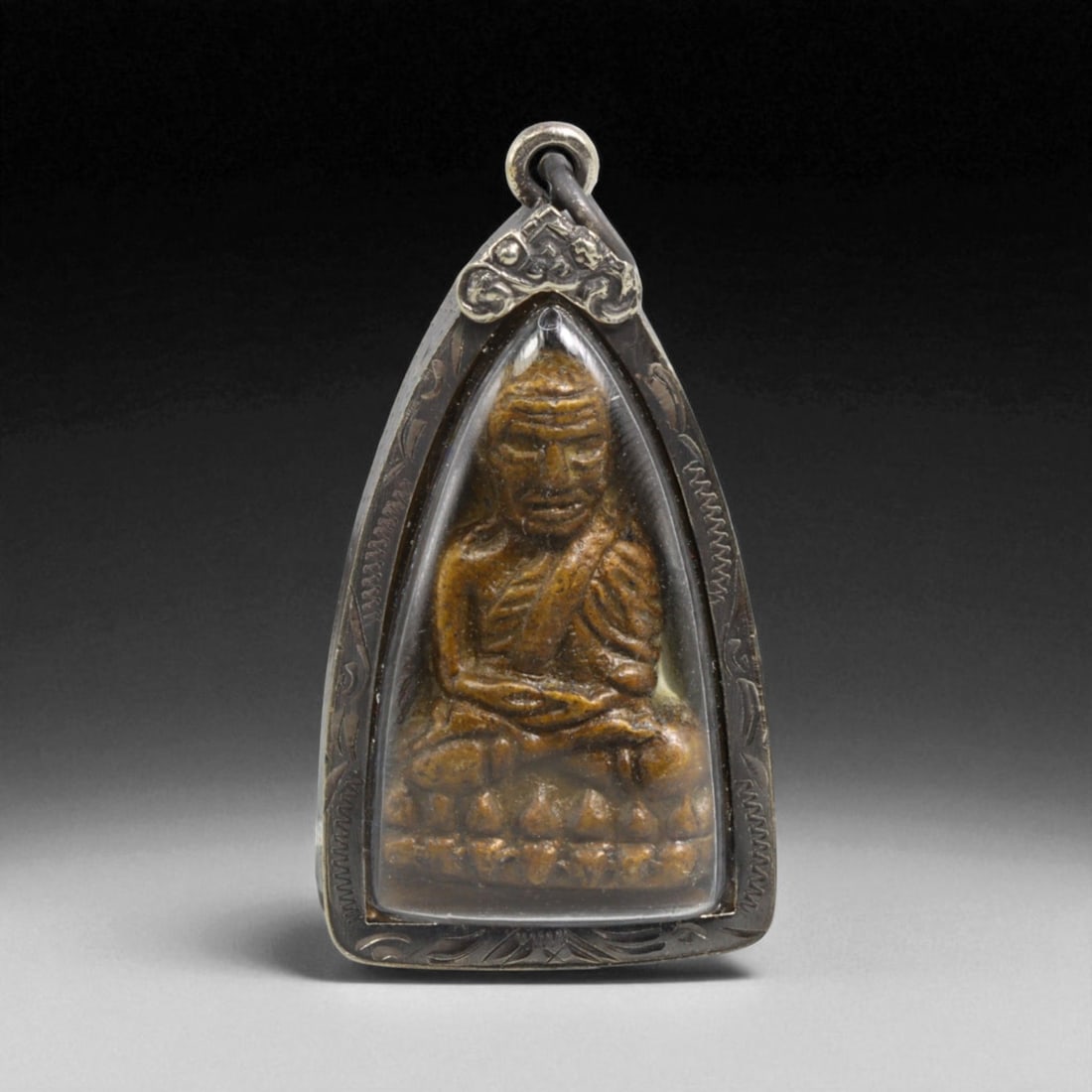 Vintage Thai Luang Pu Thuad Monk Amulet in Carved Teardrop Frame, 20th Century, 34g: This vintage Thai amulet honors the legendary monk Luang Pu Thuad, renowned across Thailand for his miraculous deeds and protective power. Crafted in the 20th century, the amulet presents a richly det