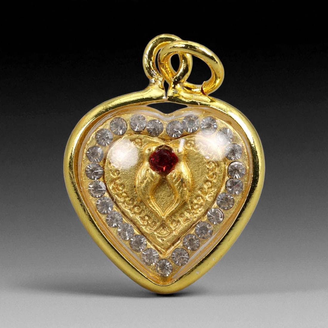 Thai Temple Gilt Buddhist Amulet in Ornate Gold-Tone Frame, 2.5cm: This beautifully crafted gilt Buddhist amulet is enclosed within an intricately designed gold-tone frame, combining sacred symbolism with refined artistry. The detailed relief and lustrous finish refl