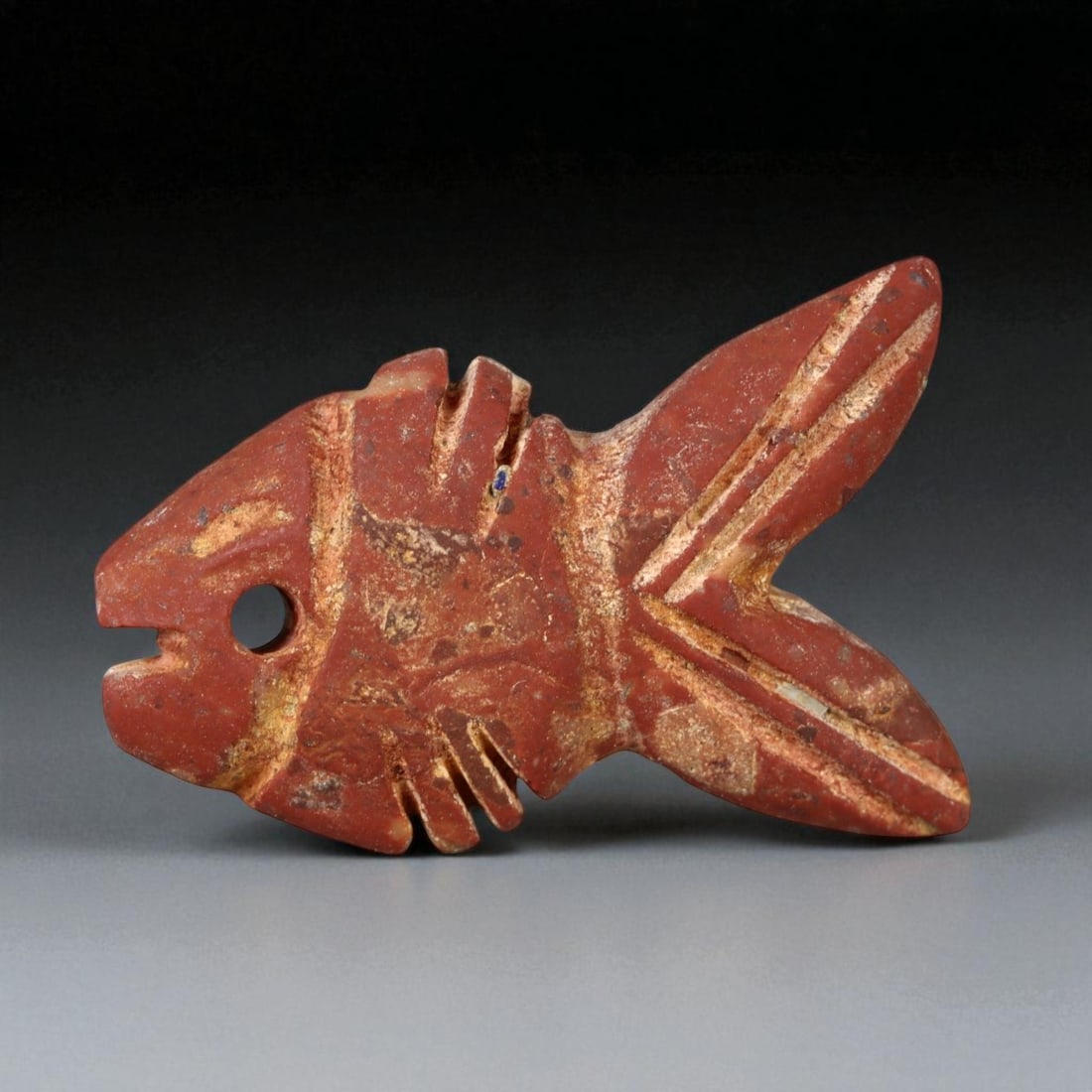 Ancient Indus Valley Red Jasper Fish Amulet, c. 2600-1900 BCE, 3.2cm: This finely carved red jasper amulet, depicting a stylized fish, originates from the Indus Valley Civilization, one of the earliest centers of urban and artistic achievement in human history (c. 2600-
