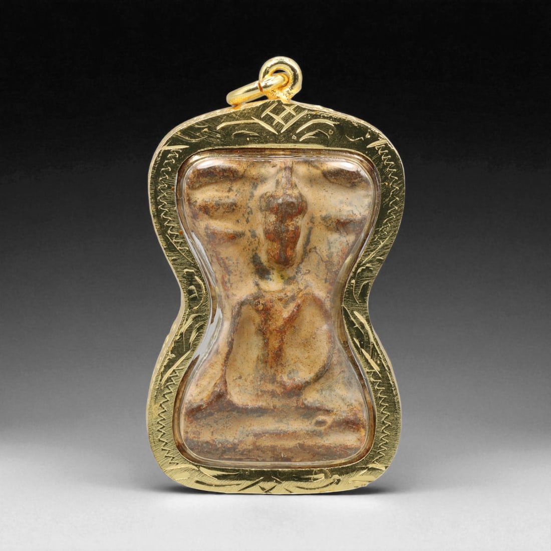 Thai Temple Gilt Buddhist Amulet in Ornate Gold-Tone Frame, 5.5cm: This beautifully crafted gilt Buddhist amulet is enclosed within an intricately designed gold-tone frame, combining sacred symbolism with refined artistry. The detailed relief and lustrous finish refl