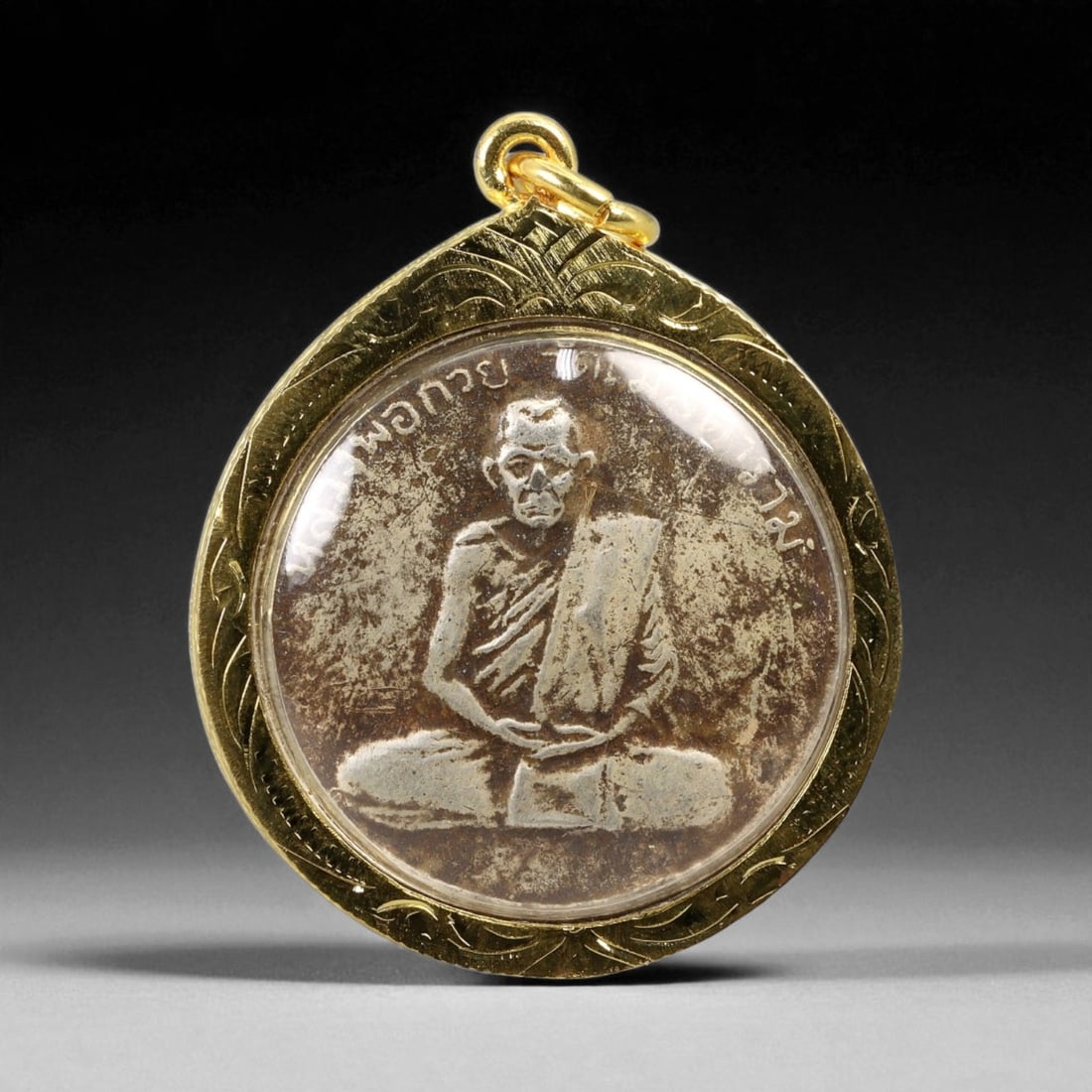 Thai Temple Style Gilt Buddhist Amulet in Ornate Gold-Tone Frame, 4.5cm: This beautifully crafted gilt Buddhist amulet is enclosed within an intricately designed gold-tone frame, combining sacred symbolism with refined artistry. The detailed relief and lustrous finish refl