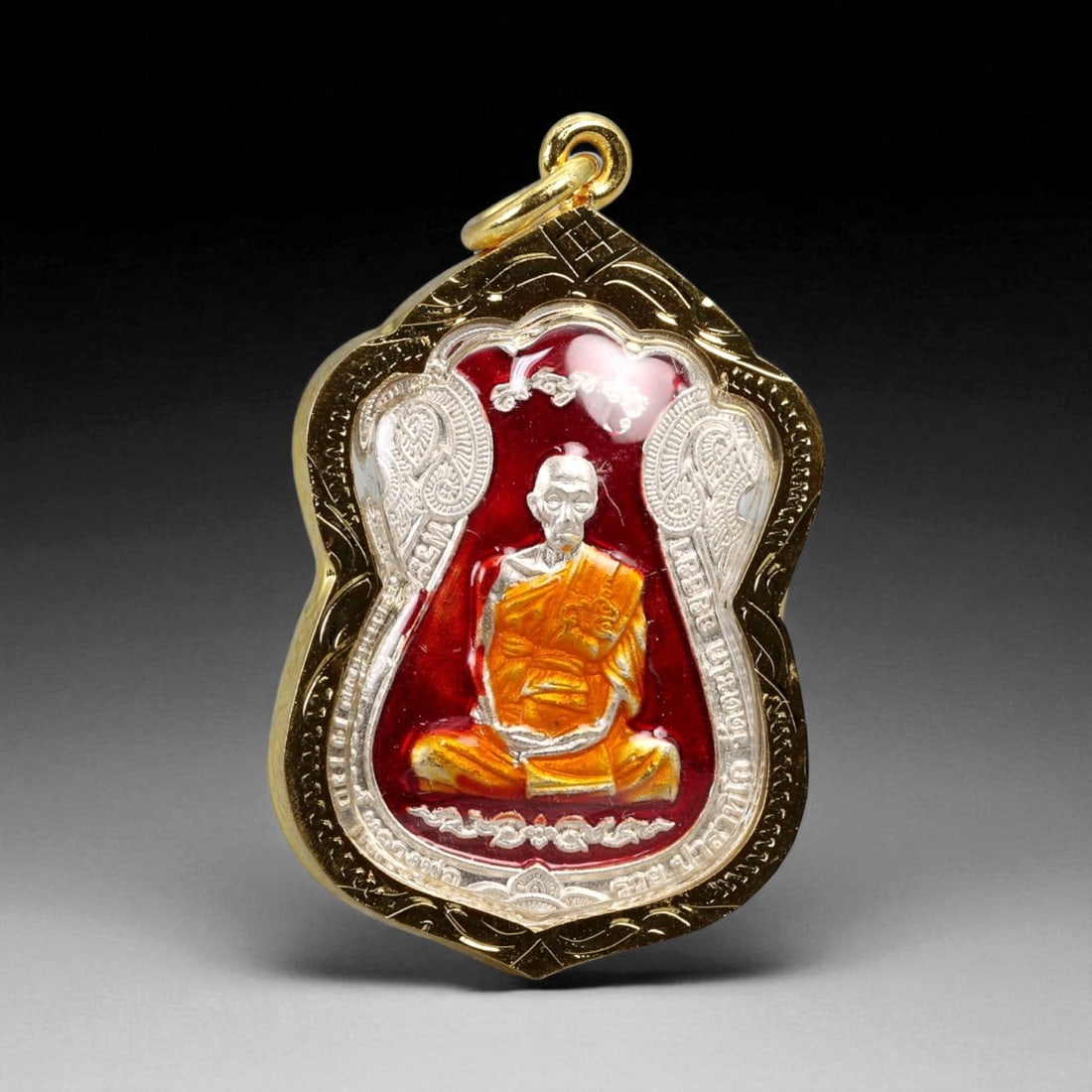 Thai Temple Style Gilt Buddhist Amulet in Ornate Gold-Tone Frame, 4.7cm: This beautifully crafted gilt Buddhist amulet is enclosed within an intricately designed gold-tone frame, combining sacred symbolism with refined artistry. The detailed relief and lustrous finish refl