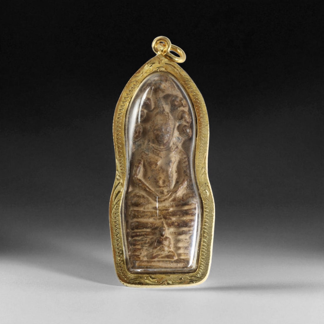 Antique Thai Rattanakosin Clay Buddha Amulet in Gilt Frame, c. 19th-20th Century, 31g: This antique Thai amulet from the late Rattanakosin period (c. 19th-20th century) is crafted from sacred clay and depicts a seated Buddha framed within a tall, elongated niche. The amulet measures 7x3