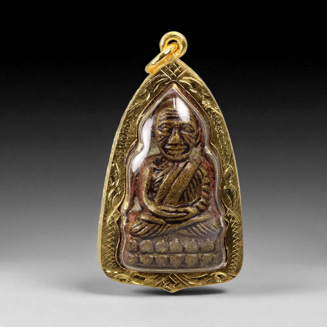 Thai Temple Style Gilt Buddhist Amulet in Ornate Gold-Tone Frame, 5cm: This beautifully crafted gilt Buddhist amulet is enclosed within an intricately designed gold-tone frame, combining sacred symbolism with refined artistry. The detailed relief and lustrous finish refl