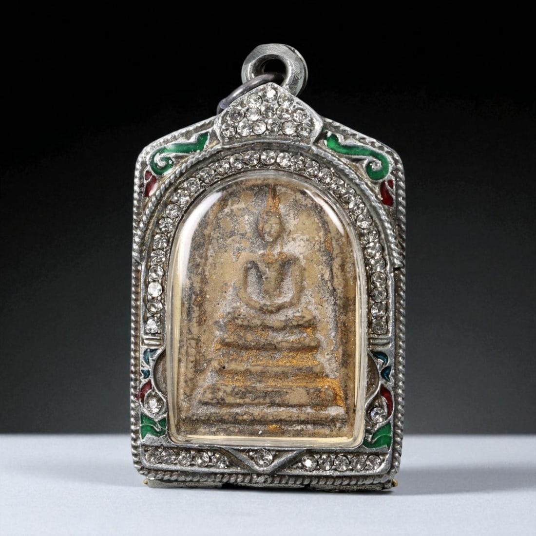 Vintage Thai Buddhist Amulet in Ornate Framed Setting, 20th Century, 6cm: This vintage Thai Buddhist amulet exemplifies the devotional artistry that continues to define Thailand's sacred craftsmanship. Encased within an intricately detailed frame, the amulet displays refine