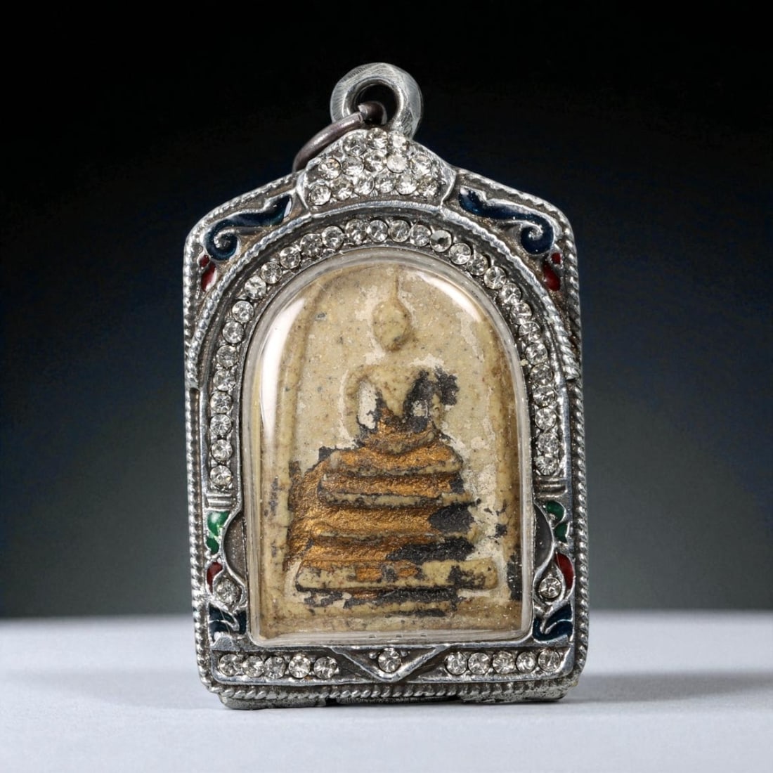 Vintage Thai Buddhist Amulet in Ornate Framed Setting, 20th Century, 6cm: This vintage Thai Buddhist amulet exemplifies the devotional artistry that continues to define Thailand's sacred craftsmanship. Encased within an intricately detailed frame, the amulet displays refine