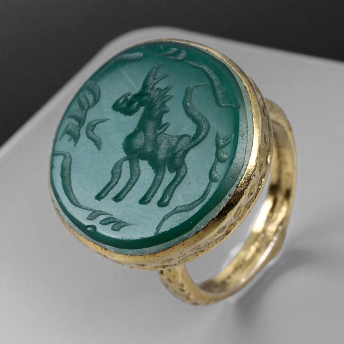 Antique Qajar Gold Gilt Intaglio Signet Ring, c. 19th-20th Century, 8 US, 15g: This substantial gilt ring, dating to the Qajar era of the 19th-20th century, embodies the regal aesthetic and cultural refinement of Persian jewelry traditions. The bezel is set with an engraved inta