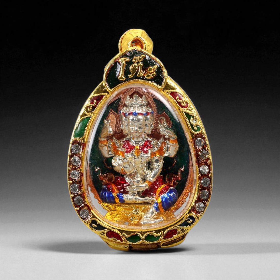 Thai Temple Style Gilt Buddhist Amulet in Ornate Gold-Tone Frame, 5cm: This beautifully crafted gilt Buddhist amulet is enclosed within an intricately designed gold-tone frame, combining sacred symbolism with refined artistry. The detailed relief and lustrous finish refl
