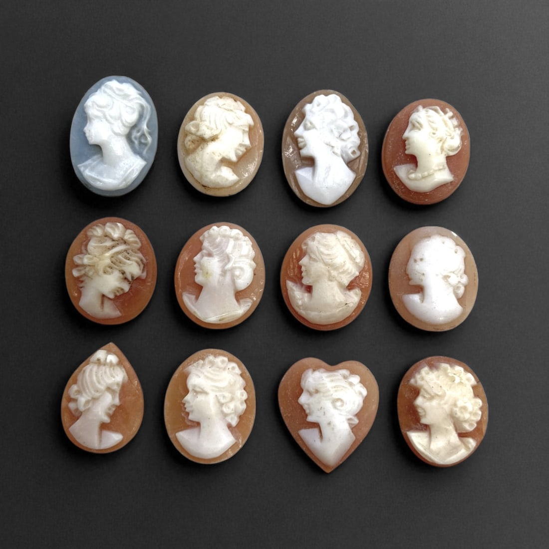 Antique European Cameo Portrait Cabochons, c. 19th-Early 20th Century CE, 1-1.5cm, 6g: This refined collection of twelve miniature cameo portrait cabochons reflects the enduring European fascination with classical beauty and Neoclassical artistry during the 19th and early 20th centuries