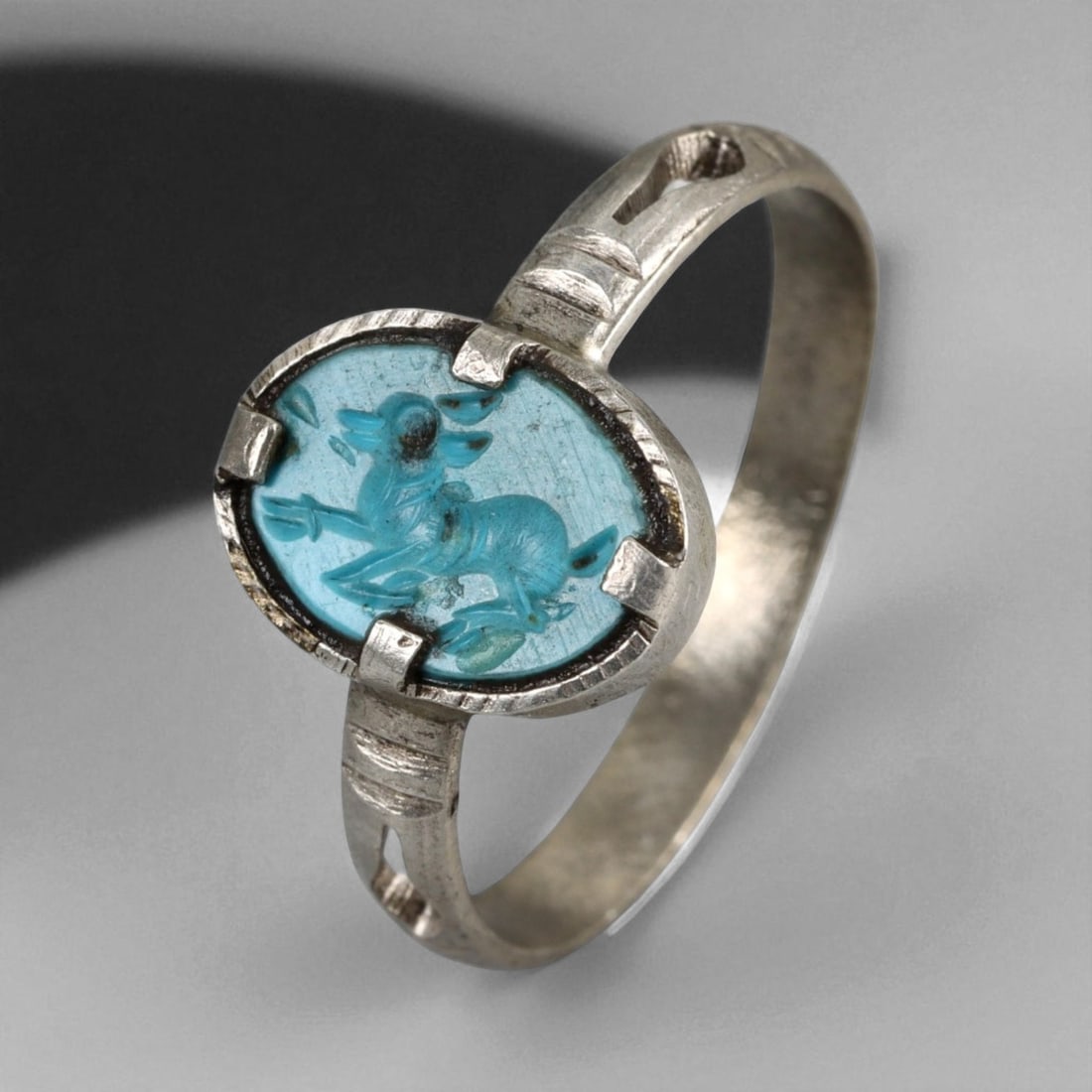 Antique Persian Turquoise Intaglio Deer Silver Ring, c. 19th Century 2g: This elegant antique silver ring from 19th century Persia reflects the refined artistry of the Qajar dynasty, when jewelry often carried layers of symbolic and talismanic meaning. The centerpiece is a