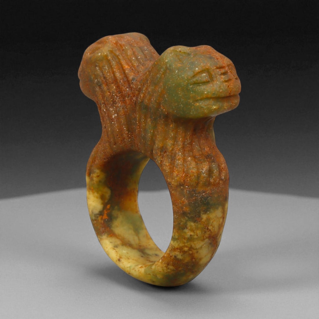 Ancient Parthian Double-Head Lapis Lazuli Ring, c. 2nd-1st Century BCE, 4.1 cm: This remarkable ring, sculpted from vibrant lapis lazuli, represents the artistic refinement and spiritual symbolism of the Parthian Empire. The dual-headed motif, emerging from the shoulders of the r